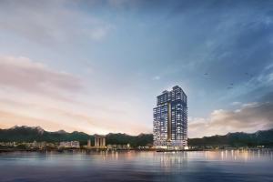 江陵市Gangneung Chonpines Ocean Suites Hotel的水体中间的高楼