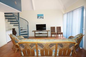 a living room with a couch and a tv at Osprey Holiday Village Unit 119 in Exmouth