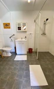 a bathroom with a shower and a toilet and a sink at Byron Bay Hinterland Eco-Retreat Ivory Yurt in Eureka