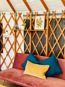 a living room with a red couch at Byron Bay Hinterland Eco-Retreat Ivory Yurt in Eureka