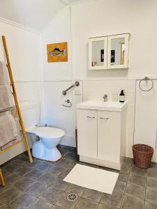 a bathroom with a toilet and a sink at Byron Bay Hinterland Eco-Retreat Ivory Yurt in Eureka