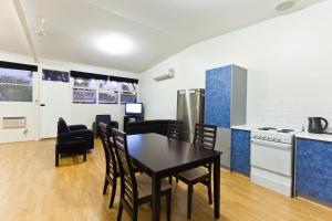 a kitchen and dining room with a table and chairs at Exmouth Villas Unit 33 in Exmouth