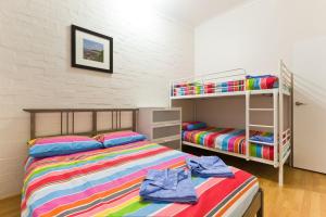 a bedroom with two beds and a bunk bed at Exmouth Villas Unit 33 in Exmouth