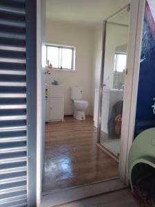 a bathroom with a toilet and a mirror at Brett's Rest Nel in Kingscote