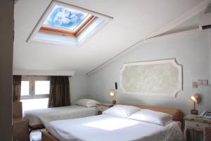 Postel nebo postele na pokoji v ubytování Hotel Tahiti