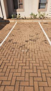 a brick parking lot in front of a building at Homely Apartment, Hatfield, Unit-9 in Pretoria