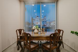 a dining room table with chairs and a large window at Hotel Alkyon in Paralia Katerinis