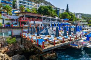 a bunch of umbrellas and chairs on a dock at Sea View Hotel in Kas