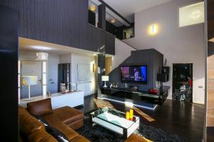 A television and/or entertainment centre at ZENLUXE Villa Planet Costa Dorada