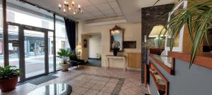 a lobby of a building with a waiting room with at Hôtel du Palais in Évian-les-Bains +38 photos