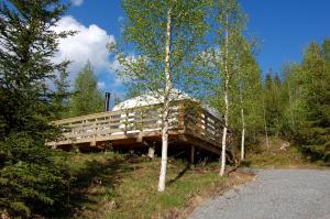 a building on the side of a hill with trees at Halvorseth in Prestfoss