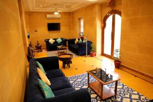 a living room with a couch and a table at Treebo Trend Chandrangan Excellency 1 Km From Jaisalmer Fort in Jaisalmer