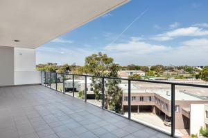 a balcony with a view of the city at KOZYGURU Parramatta Lovely 2 BED APT Free Parking NPA006 in Sydney