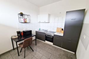 una pequeña cocina con mesa y nevera en Langenfeld Apartment en Langenfeld