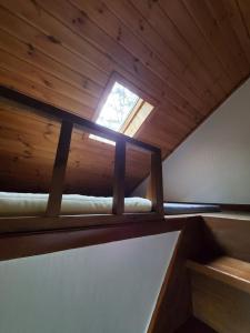 a loft bed in a room with a window at Mayfare Narsha Pyeongchang in Pyeongchang