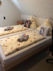 two beds with stuffed animals on top of them at Ferienwohnung Bodensee LA in Langenargen