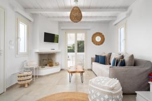 a living room with a couch and a tv at Pyrgaki Beach Villa in Aliko Beach