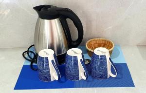 a tea kettle and some spoons on a table at Sapphire Boutique Resort in Panglao