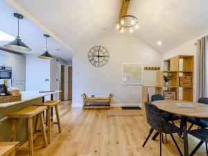 a kitchen and dining room with a table and chairs at Rinstone Lodge, Thornton-Le-Dale. Moors cottage with hot tub in Thornton Dale