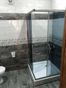 a shower with a glass door in a bathroom at Hill House in Stepantsminda +35 photos