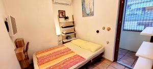 a small bedroom with a small bed in a room at Apartmaji Sonce Izola in Izola