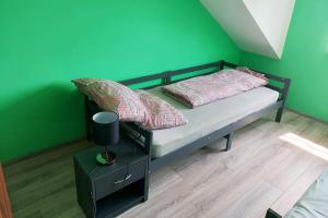 a bedroom with a bed with a green wall at 4 room apartment in Düren in Düren - Eifel