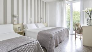 Postel nebo postele na pokoji v ubytování Hotel Carignano + 9 fotografií