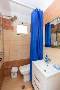 a bathroom with a toilet and a sink and a shower at PREMIER GUEST HOUSE in Vlorë +16 photos