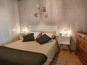 a bedroom with a large bed with two lamps on it at La maison d'Yvette - Gîte avec piscine, terrasse privée et vue in Le Barroux