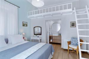 a white bedroom with a bunk bed and a mirror at Villa Remedio in Néon Khoríon