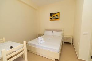 a small bedroom with a bed with towels on it at PREMIER GUEST HOUSE in Vlorë