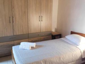a bedroom with a large bed with wooden cabinets at Orne Magical Retreat in Orné
