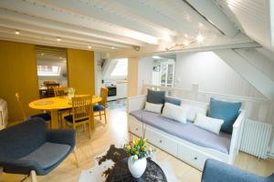 a living room with a couch and a table at Appartement Les Tournesols avec Climatisation in Kaysersberg