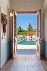 an open door leading to a swimming pool seen from a house at Villa Remedio in Néon Khoríon
