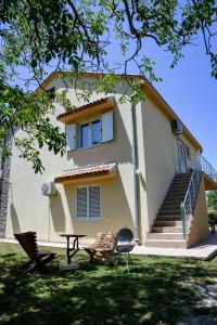 a house with a table and a chair in front of it at Apartment Nikola in Kotor