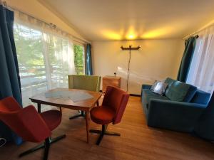 a living room with a table and chairs and a couch at Siedlisko Bartek in Sulęczyno