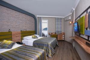 Postel nebo postele na pokoji v ubytování Monart City Hotel - All Inclusive Plus