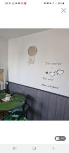 a picture of a restaurant with a table and a sign at Appartement cosy en plein centre in Guidel