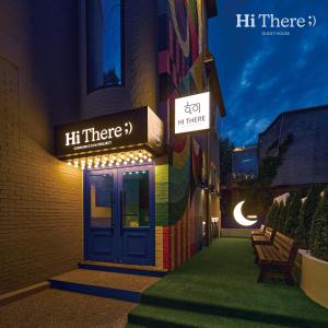 a building with a blue door and a sign that reads hi there at Hithere guesthouse in Seoul