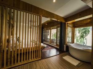 a bathroom with a tub and a bedroom at Famree Resort Hunza in Hunza Valley +165 photos