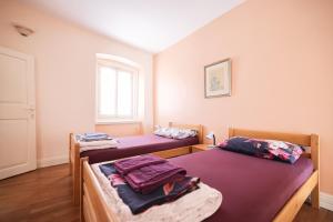 a room with two beds and a window at Two bedroom apartment in city center Igor in Zadar