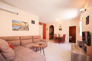 a living room with a couch and a tv at Two bedroom apartment in city center Igor in Zadar