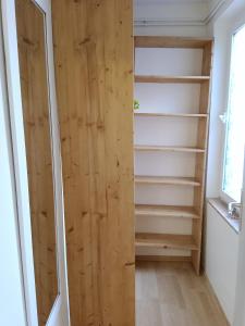 a walk in closet with a wooden door at Hof Kranichweide, Ferienwohnung "Granilager" in Saal