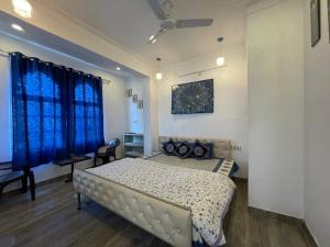 Schlafzimmer mit einem Bett mit blauen Vorhängen in der Unterkunft Boraj Haveli Guest House in Udaipur