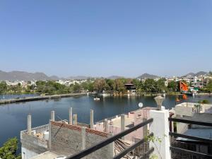 a view of a river with boats in it at Boraj Haveli Guest House in Udaipur
