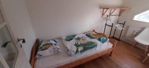 a bed with two pillows on it in a room at B&B Idala in Mellerud +11 photos