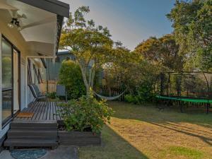 a porch with a hammock and a swing at Wonderful Whangamata - Whangamata Holiday Home in Whangamata