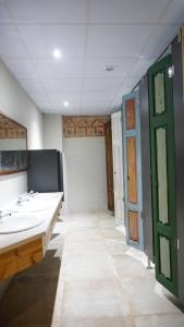 a bathroom with two sinks and a green door at FINCA ALEGRANZA in Torrelavega