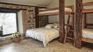 a bedroom with two bunk beds and a window at FINCA ALEGRANZA in Torrelavega