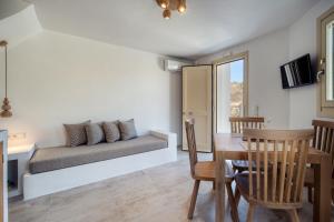 a living room with a couch and a table at Shizen Houses in Serifos Chora